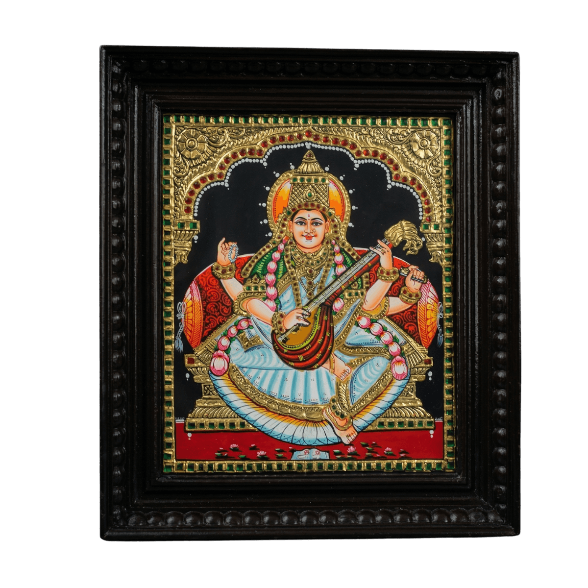 Hand-painted Tanjore painting of Goddess Saraswati seated with a Veena, featuring 22K gold foil work and kundan stones in a dark teak wood mani frame.