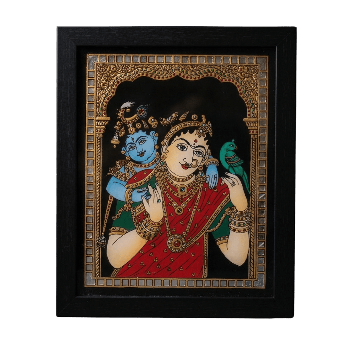 Handmade reverse glass painting by Shree Jai Arts depicting Mother Yashoda in a red sari carrying a blue-skinned baby Krishna on her back. Yashoda holds a green parrot, and the artwork is framed by an intricate gold and mirror-work border against a dark background in a premium black frame.
