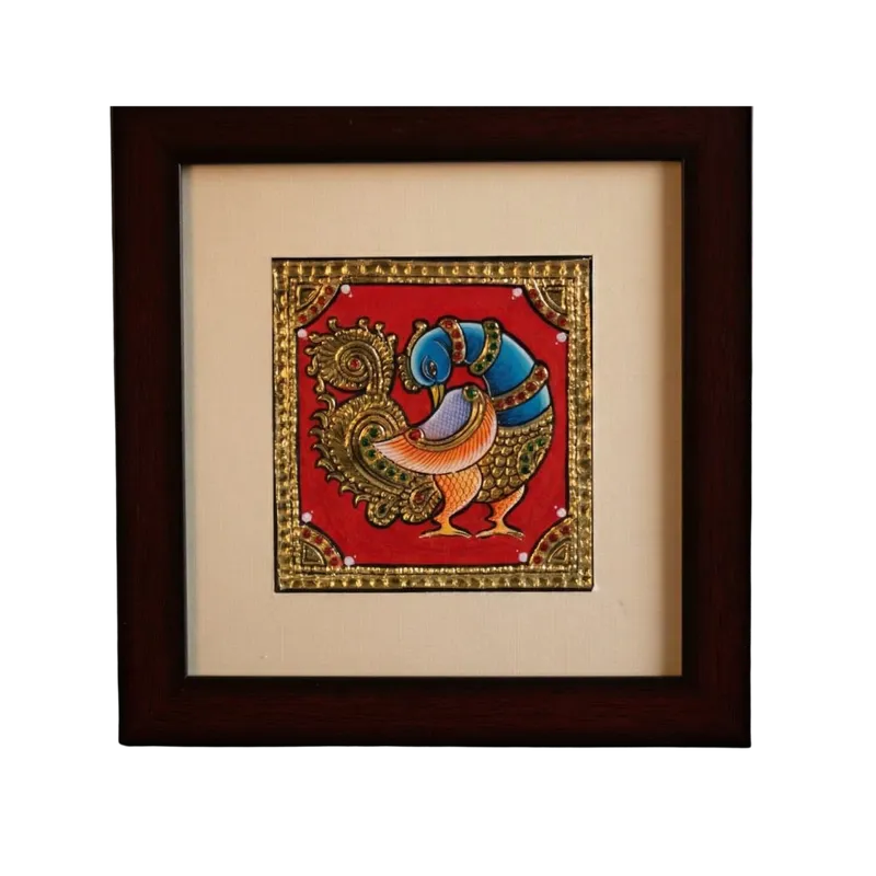 Hand-painted traditional Peacock (Mayur) Tanjore painting with 22K gold foil and semi-precious Kundan stones on a red background in a dark teak wood frame.