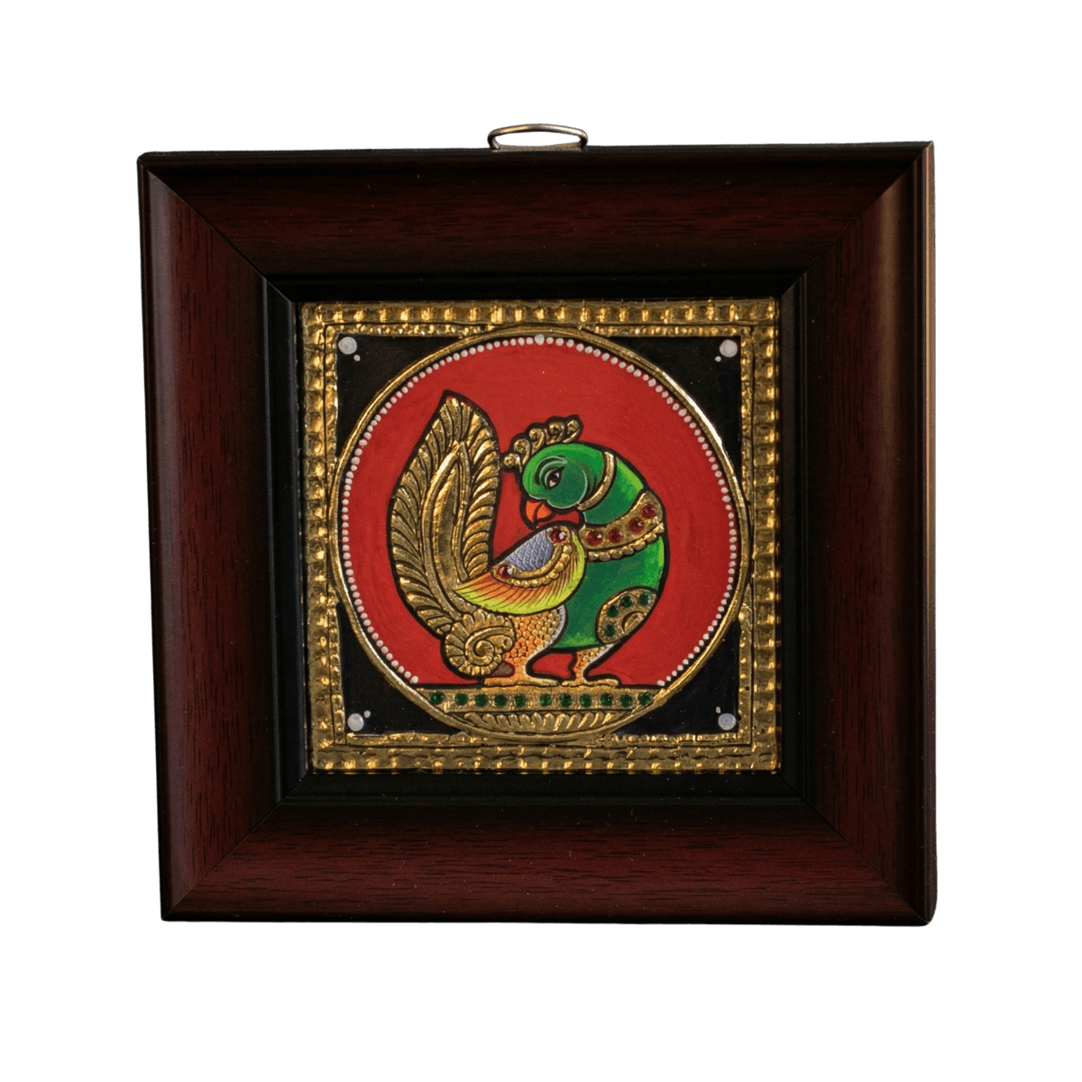 Hand-painted traditional green parrot Tanjore painting with 22K gold foil and kundan stones on a red circular background in a dark teak wood frame.