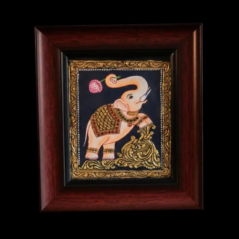 Hand-painted traditional Royal Elephant Tanjore painting with raised trunk holding a lotus, featuring 22K gold foil and kundan stones on a dark background.