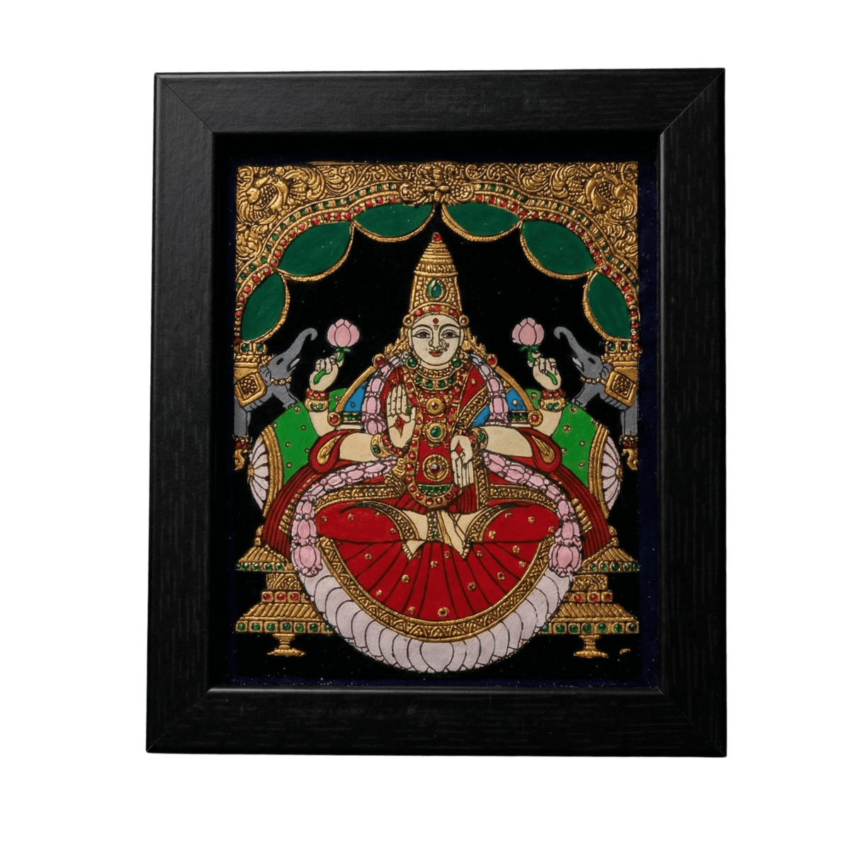 Handmade Goddess Lakshmi reverse glass painting by Shree Jai Arts. The Hindu goddess of wealth is depicted gracefully sitting on a lotus, holding pink lotus flowers, and flanked by elephants under an ornate green and gold archway, encased in a premium black frame.