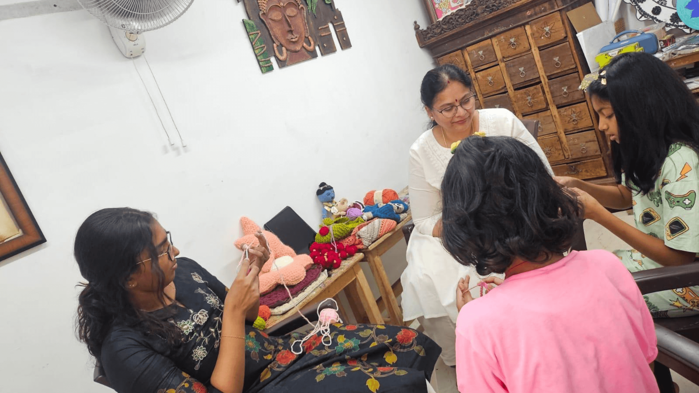 Sudha teaching a couple of kids on crochet in Shree Jai Arts Studio 