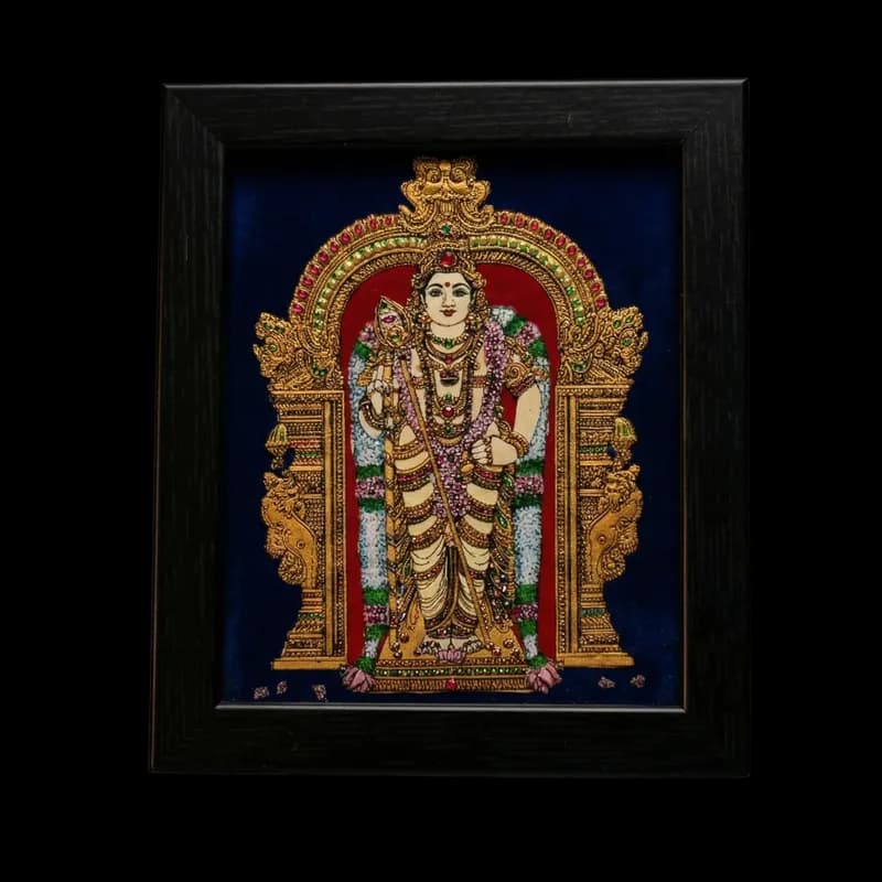 Handmade Lord Murugan reverse glass painting by Shree Jai Arts. The Hindu deity is depicted standing gracefully with his sacred Vel (spear) inside an ornate gold archway, set against a rich dark background in a premium black frame.