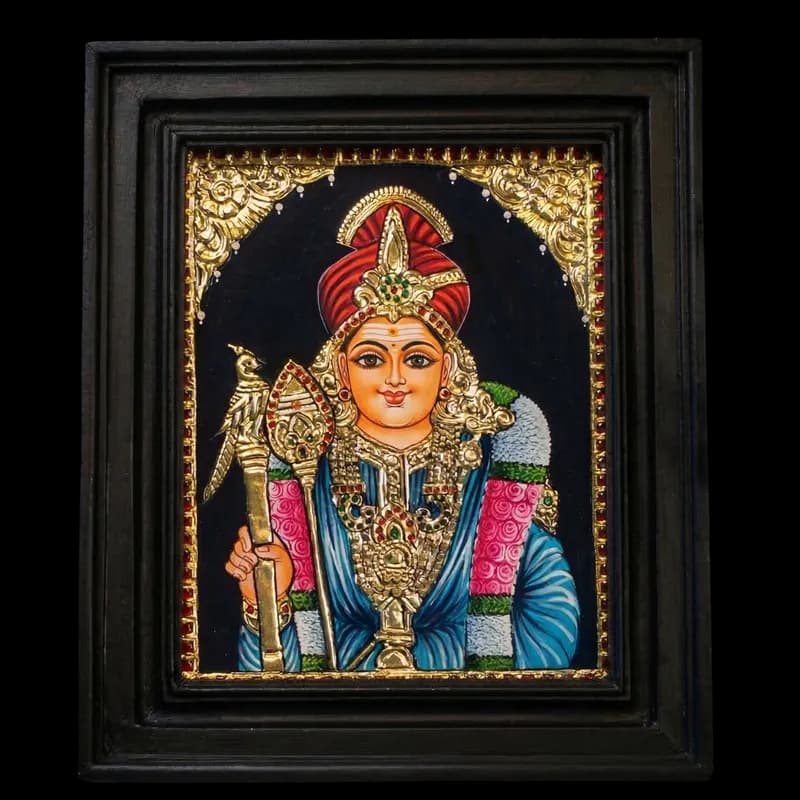 and-painted Tanjore painting of Lord Murugar in Raja Alangaram with 22K gold foil, featuring the Vel and a peacock motif, in a dark teak wood frame.