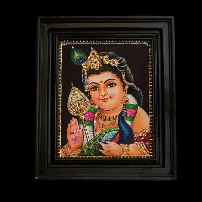 Hand-painted Tanjore painting of Bala Murugan (Child Murugan) seated with his peacock and powerful Vel, featuring detailed 22K gold foil work and kundan stones, in a dark teak wood mani frame.