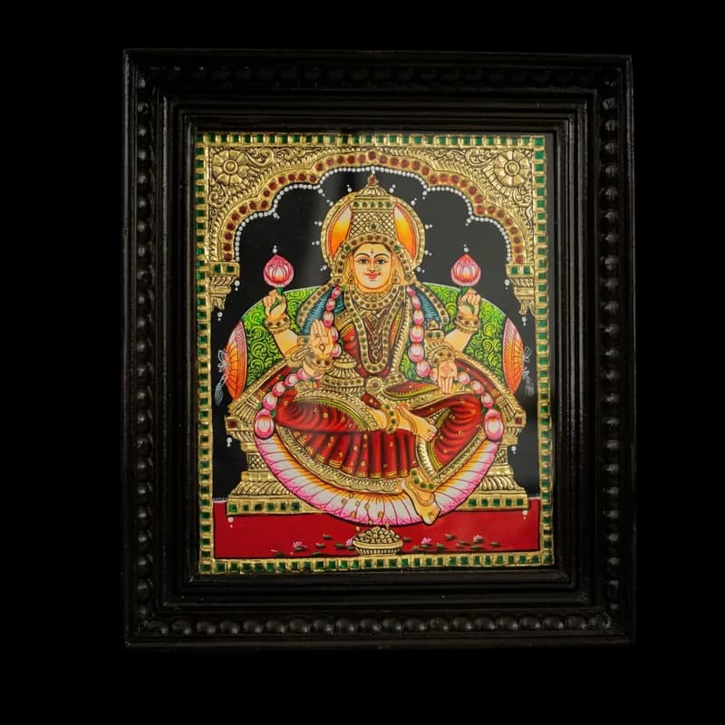 Hand-painted Tanjore painting of Goddess Lakshmi seated on a lotus, featuring 22K gold foil work and kundan stones in a dark teak wood mani frame.