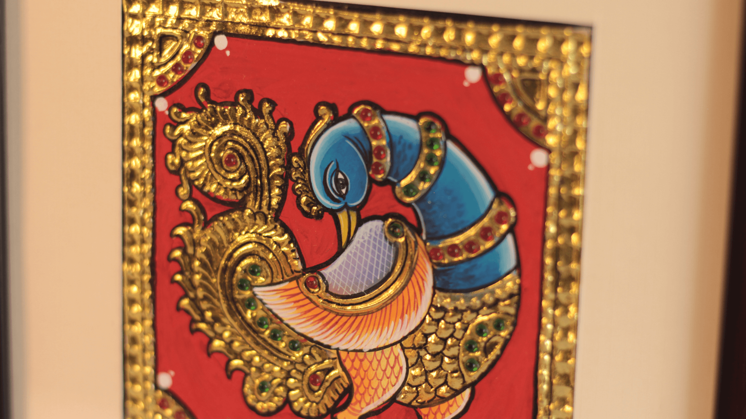 A close up of the peacock tanjore painting